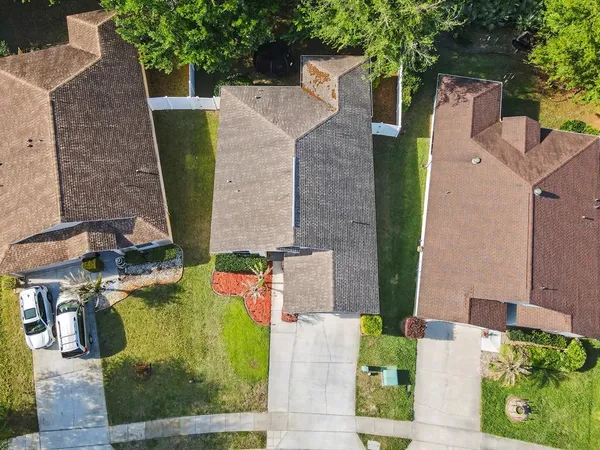 an aerial view of a house with outdoor space