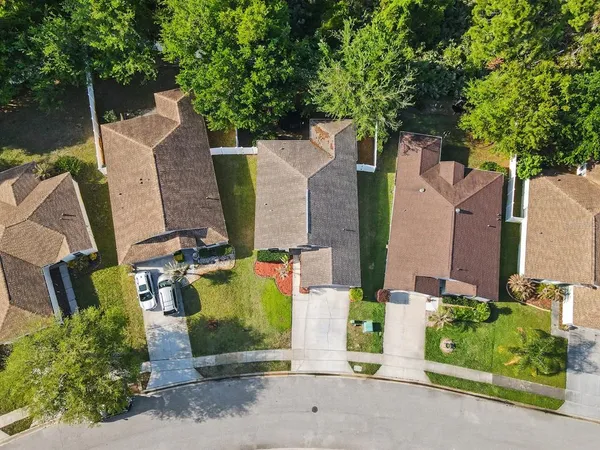 an aerial view of a house with swimming pool and garden