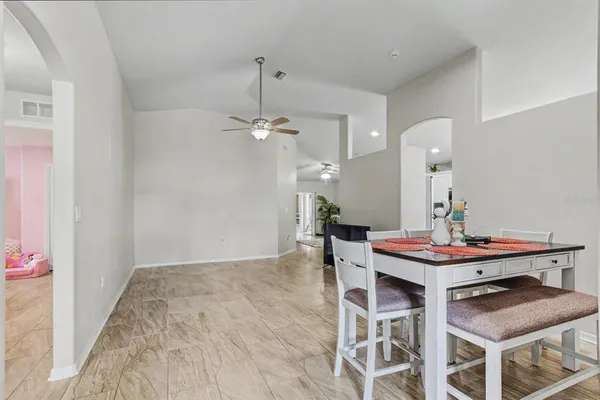 a view of a dining room with furniture and chandelier