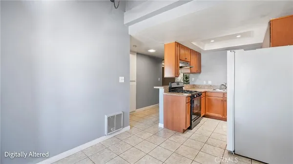 a kitchen with a refrigerator and a stove