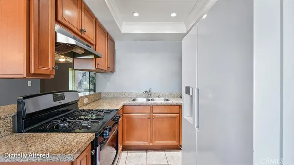 a kitchen with sink stove and cabinets