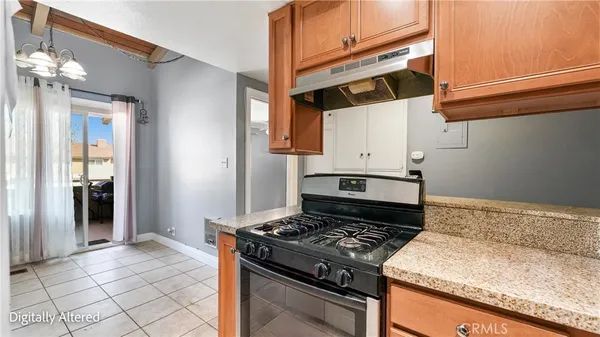a kitchen with granite countertop a stove and a sink