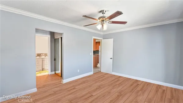 a view of a livingroom with wooden floor and a ceiling fan