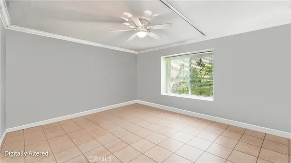 an empty room with windows and chandelier fan