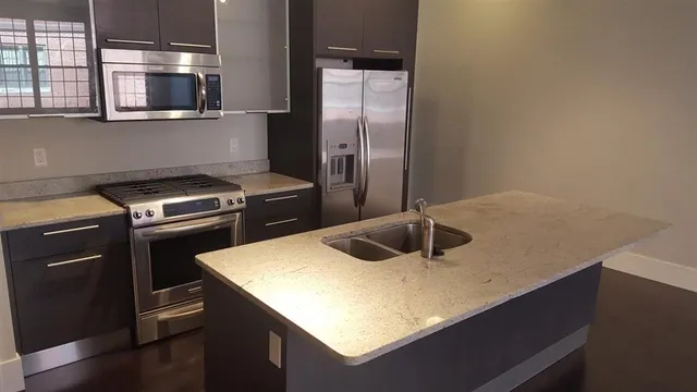 a kitchen with a sink a stove and refrigerator