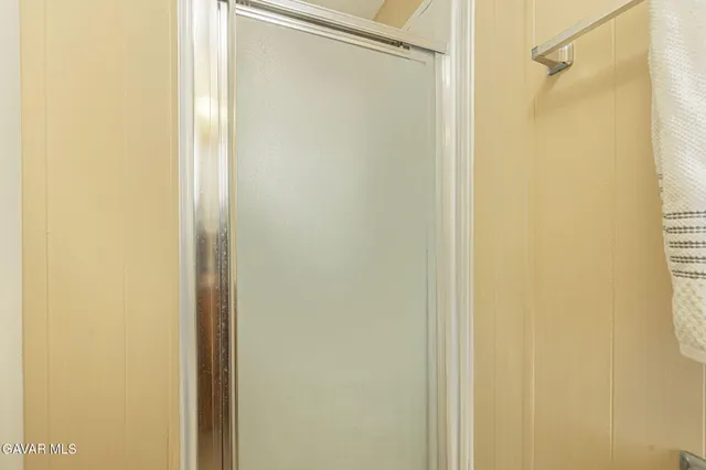 a bathroom with a glass shower door