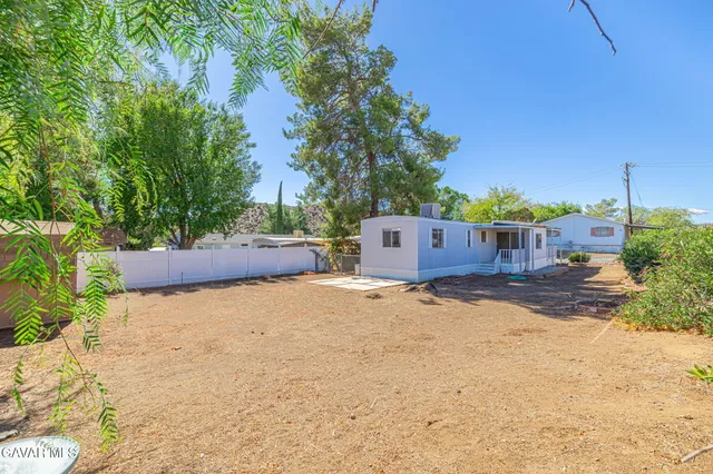 a backyard of a house with a tree