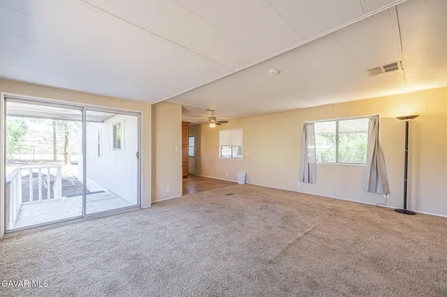 a view of an empty room with glass door