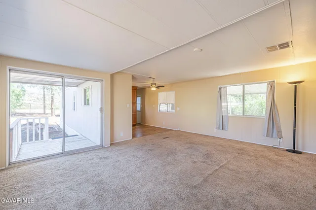 a view of an empty room with glass door