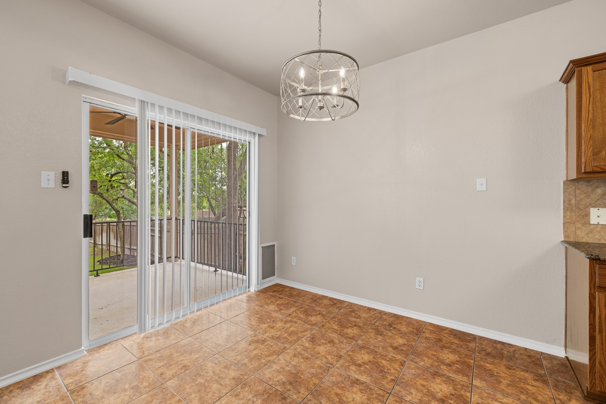 403 Red Hawk Drive Leander, TX 78641 - Photo 14 of 37 Sliding glass door opening to an outdoor patio with a ceiling fan