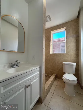 a bathroom with a sink toilet and mirror