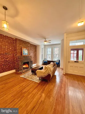 a spacious bedroom with a bed and wooden floor
