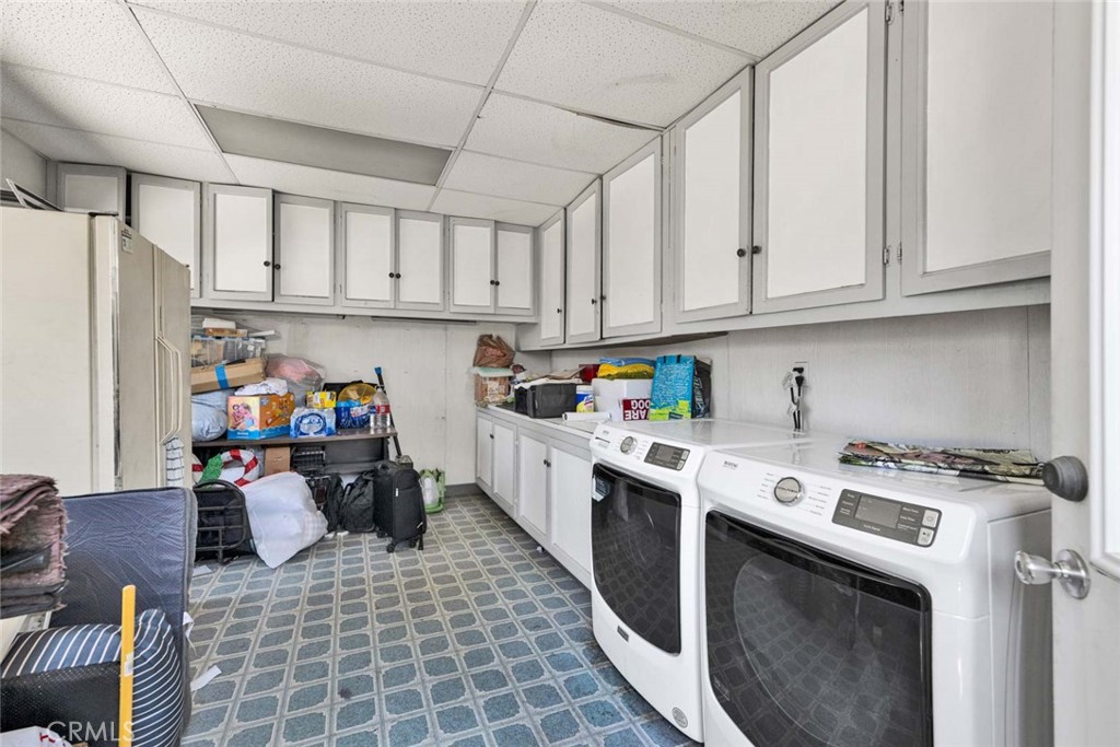 5456 Cadbury Road Whittier, CA 90601 - Photo 55 of 67 a kitchen with a stove a refrigerator and cabinets