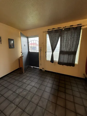 a kitchen with a sink a stove top oven and cabinetry