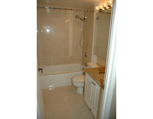 42 8th Street, Unit 5526 Boston, MA 02129 - Photo 6 of 13 a bathroom with a granite countertop bathtub shower sink and toilet