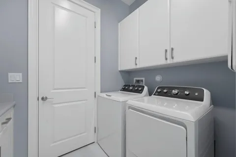 a view of a patio with a table and chairs under an umbrella