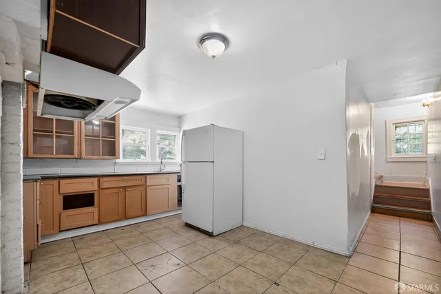 a kitchen with granite countertop a sink and a stove top oven