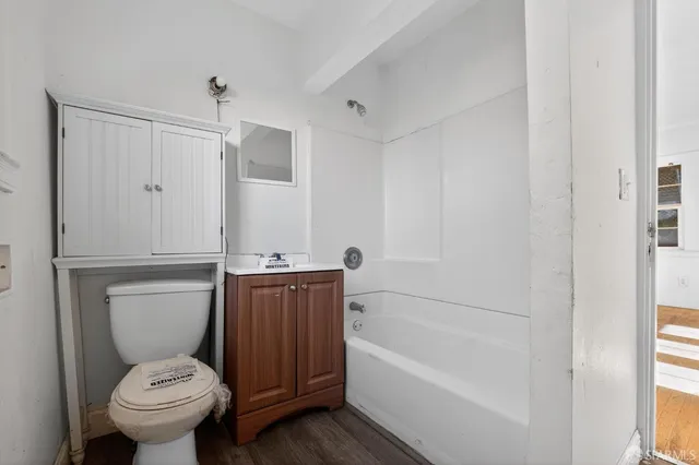 a bathroom with a toilet and bathtub