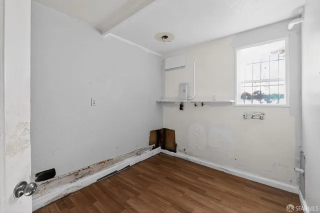 a room with a window and wooden floor