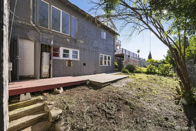 a wooden bench sitting in front of a building