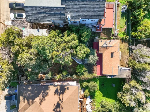 an aerial view of a house with a yard and lake view