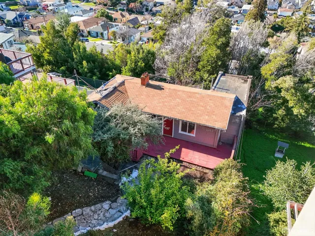 an aerial view of a house with yard swimming pool and outdoor seating