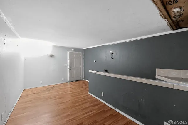 a view of a room with wooden floor