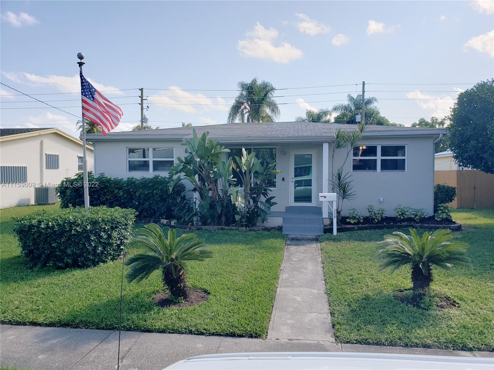 326 Southeast 3rd Terrace Dania Beach, FL 33004 - Photo 1 of 29 a front view of house with yard and green space