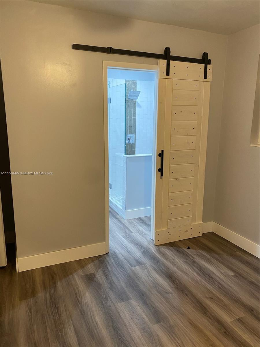 326 Southeast 3rd Terrace Dania Beach, FL 33004 - Photo 11 of 29 an empty room with wooden floor and a window
