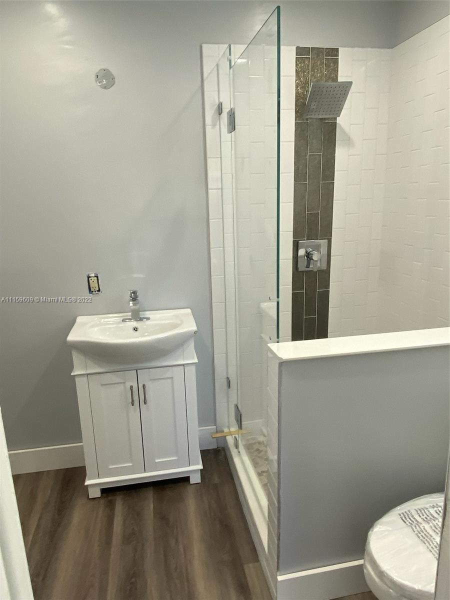 326 Southeast 3rd Terrace Dania Beach, FL 33004 - Photo 12 of 29 a bathroom with a sink a toilet and shower