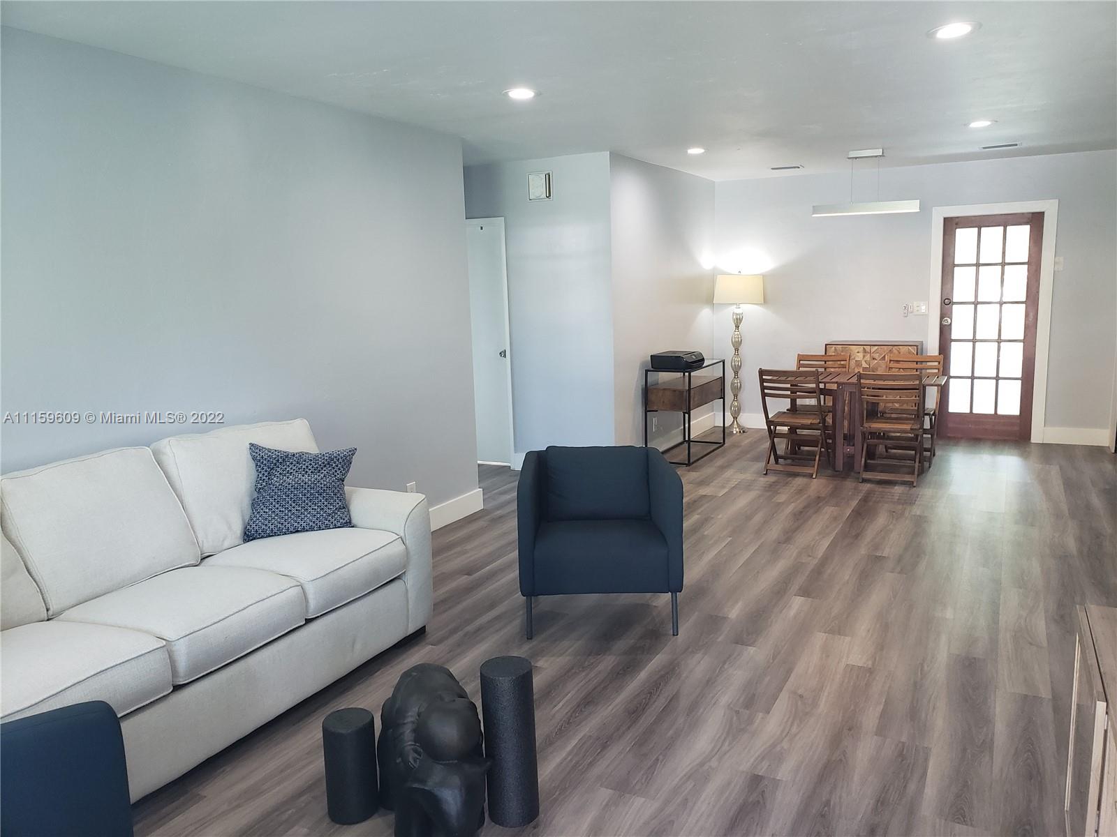 326 Southeast 3rd Terrace Dania Beach, FL 33004 - Photo 2 of 29 a living room with furniture and wooden floor