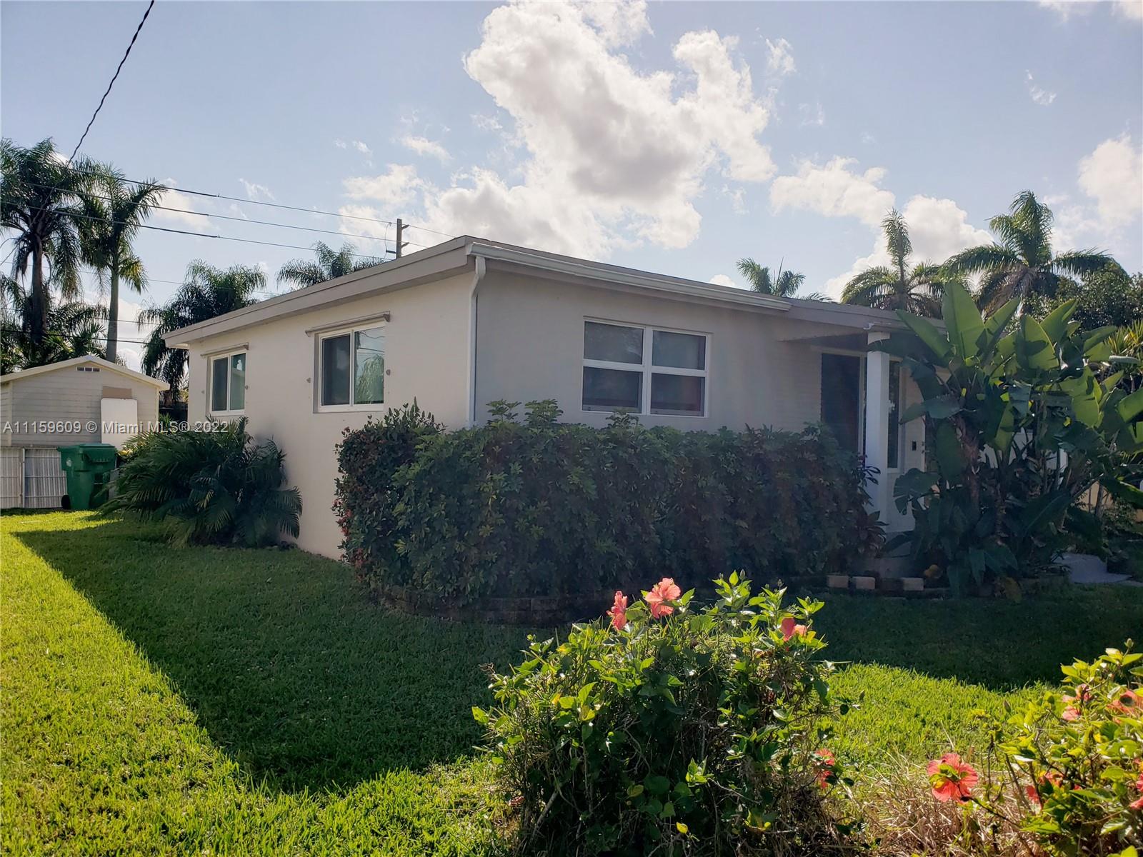 326 Southeast 3rd Terrace Dania Beach, FL 33004 - Photo 24 of 29 a house with a flower garden in front of it