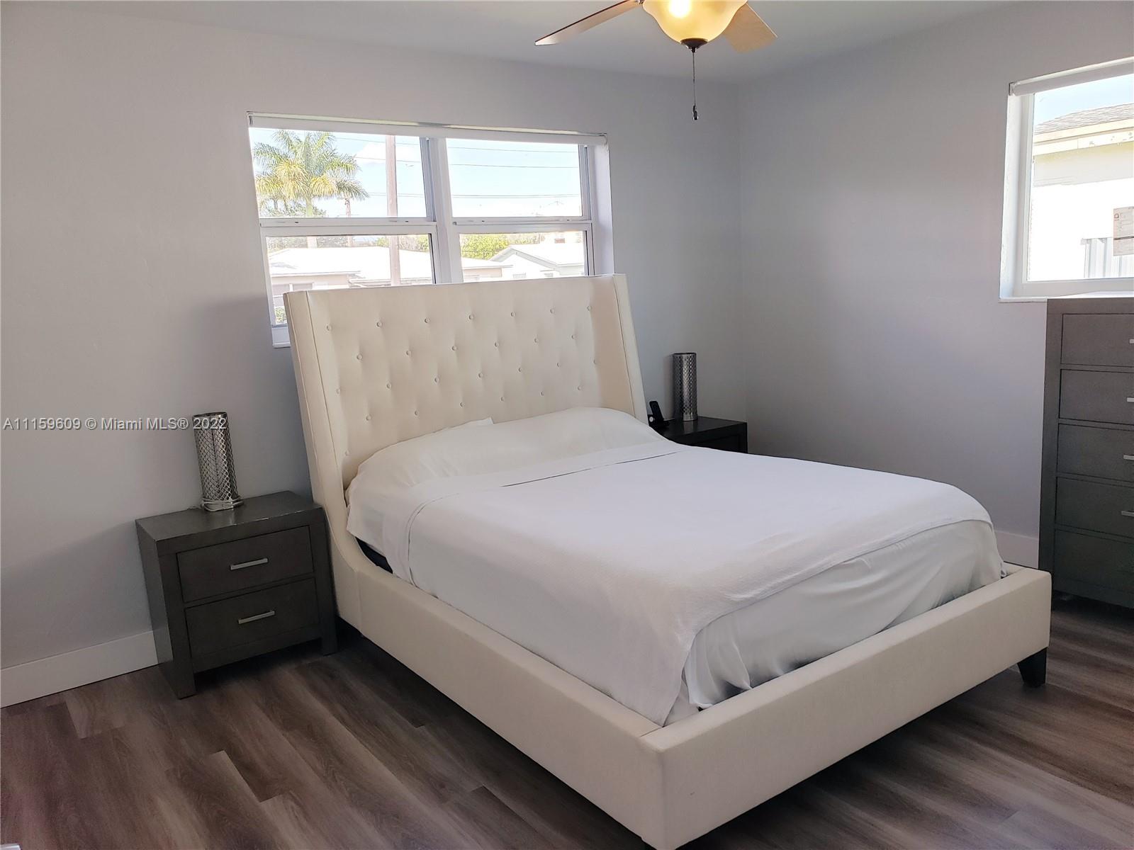 326 Southeast 3rd Terrace Dania Beach, FL 33004 - Photo 26 of 29 a bed sitting in a bedroom next to a window