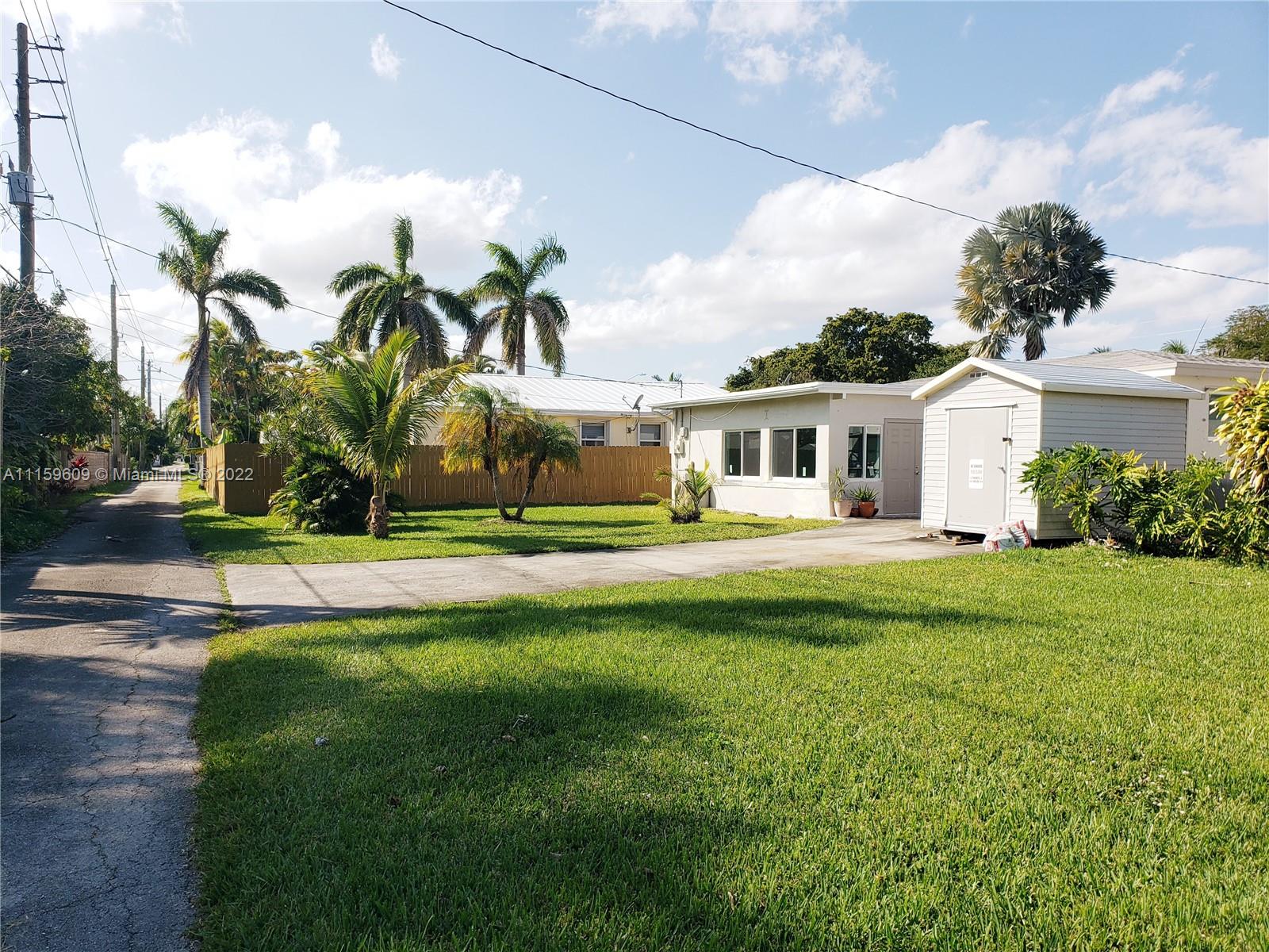 326 Southeast 3rd Terrace Dania Beach, FL 33004 - Photo 29 of 29 a front view of a house with a garden and trees