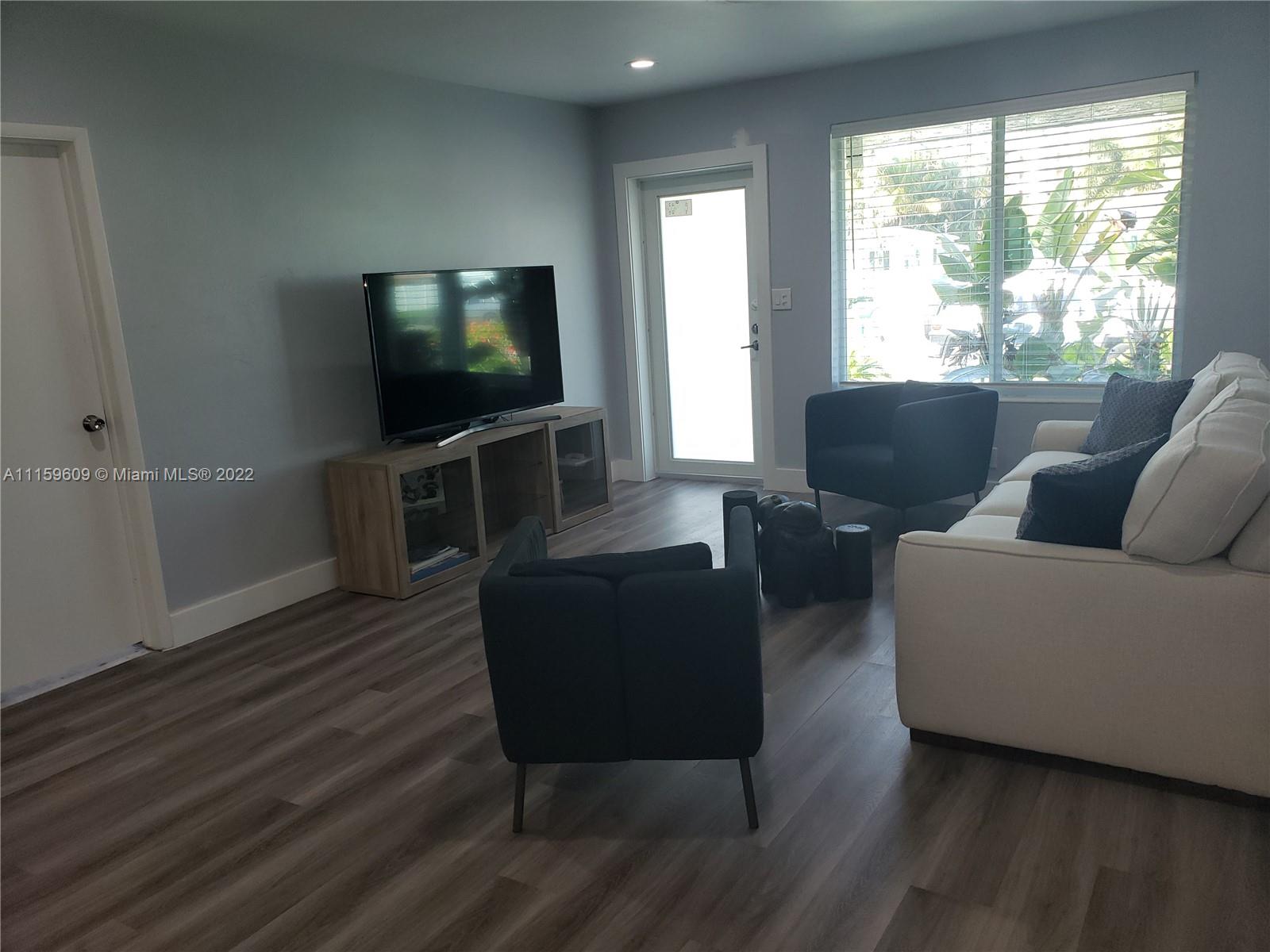 326 Southeast 3rd Terrace Dania Beach, FL 33004 - Photo 3 of 29 a living room with furniture and a flat screen tv