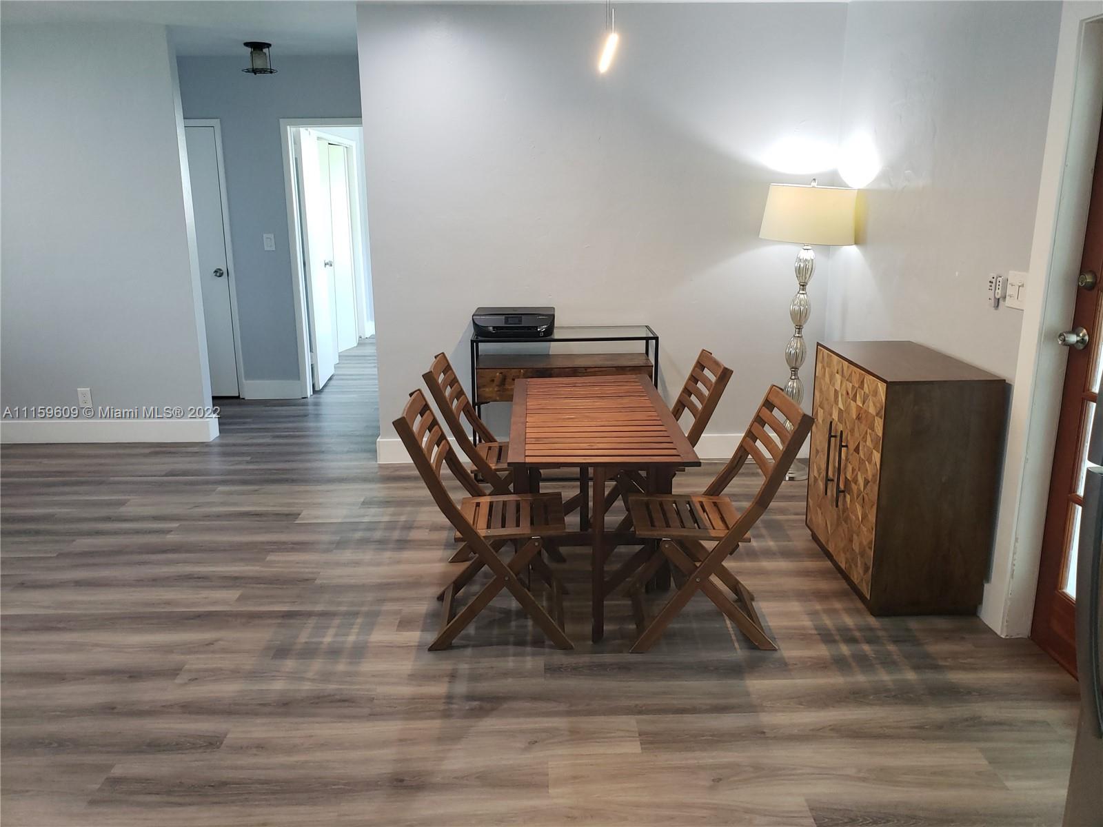 326 Southeast 3rd Terrace Dania Beach, FL 33004 - Photo 4 of 29 a dining room with furniture and wooden floor