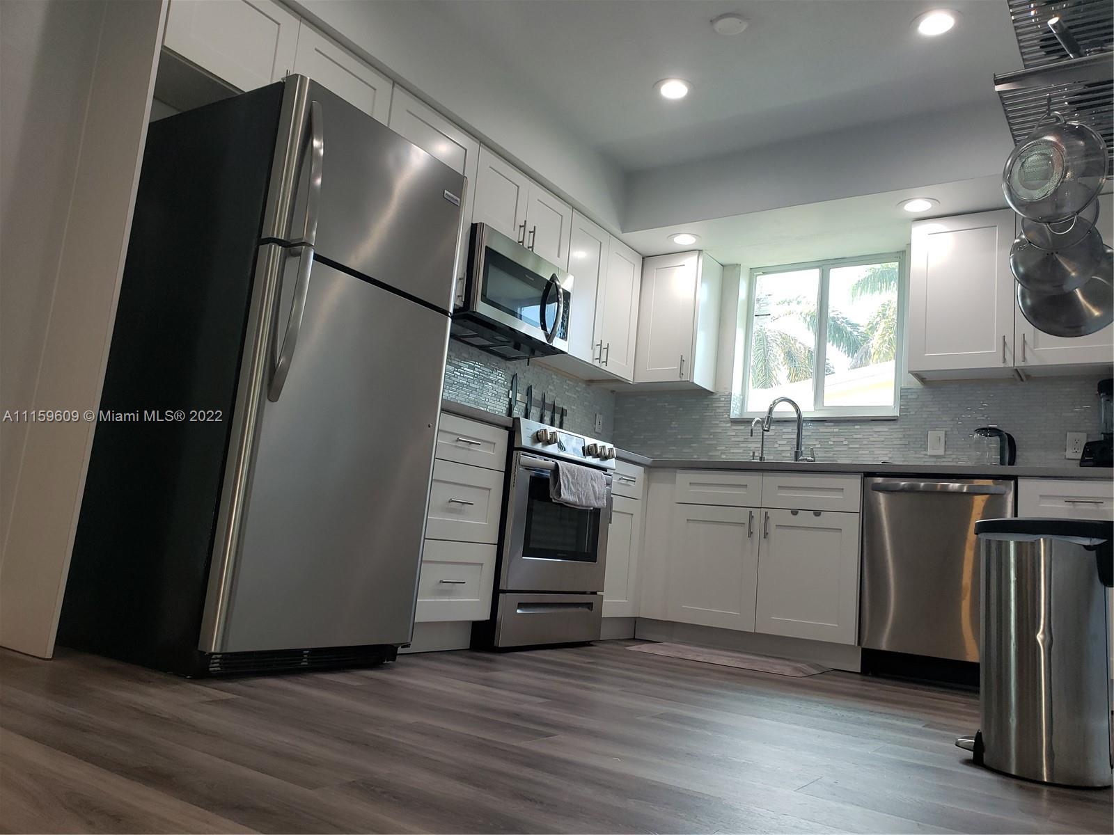 326 Southeast 3rd Terrace Dania Beach, FL 33004 - Photo 6 of 29 a kitchen with granite countertop a refrigerator a sink and a stove