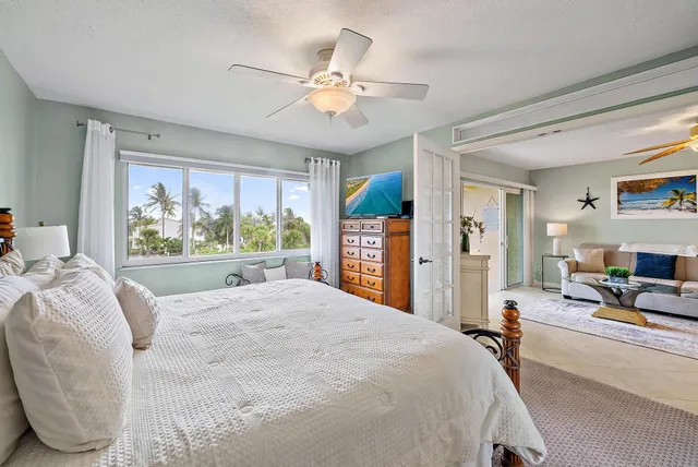 a bed room with a bed mirror and window