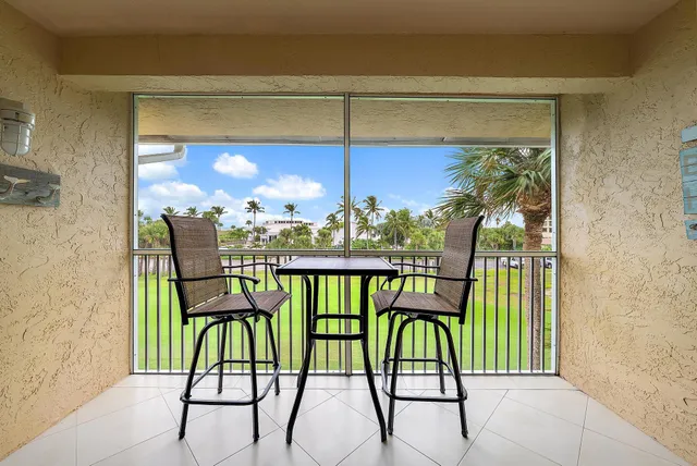a view of a chairs and table in patio