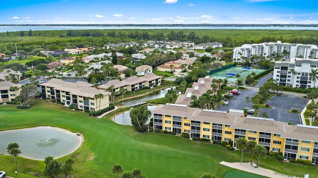 an aerial view of a houses with a lake view