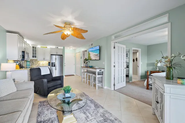 a living room with furniture and kitchen view