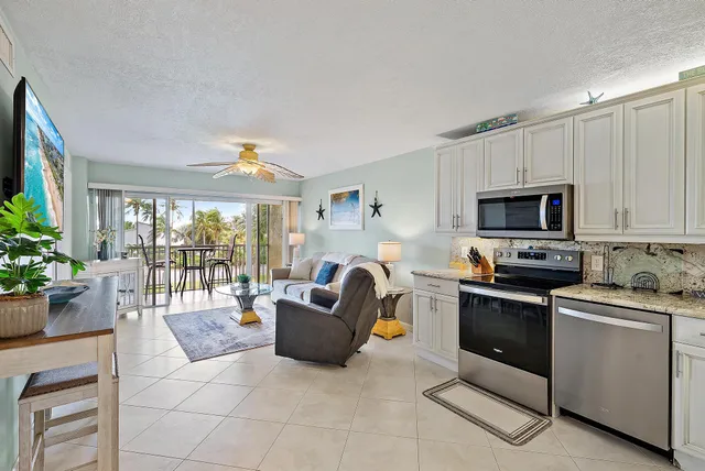 a kitchen with a sink and white cabinets