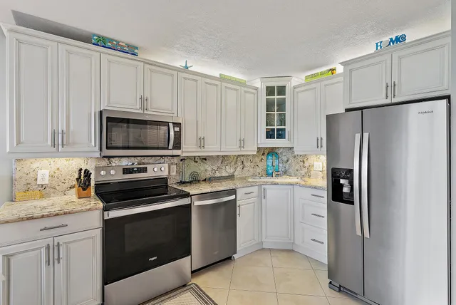 a kitchen with a sink stove and refrigerator