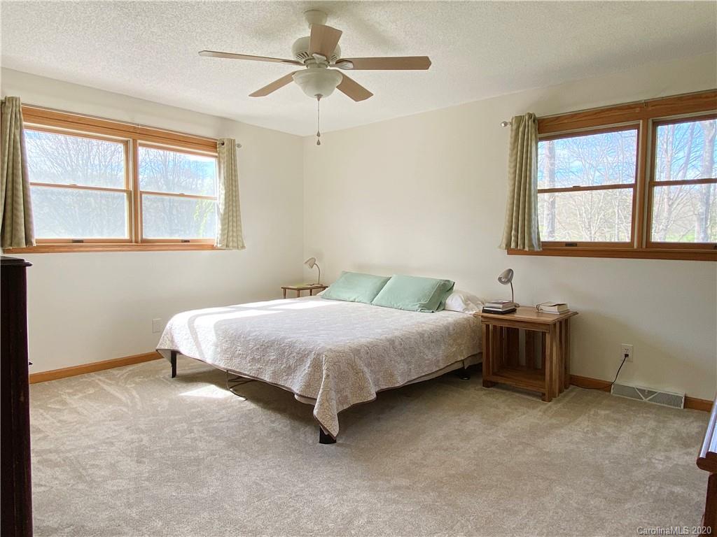 27 Morgan Branch Road Leicester, NC 28748 - Photo 17 of 39 a spacious bedroom with a bed and a window
