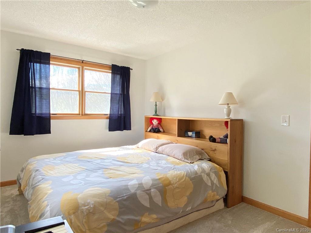 27 Morgan Branch Road Leicester, NC 28748 - Photo 22 of 39 a bedroom with a bed and a window