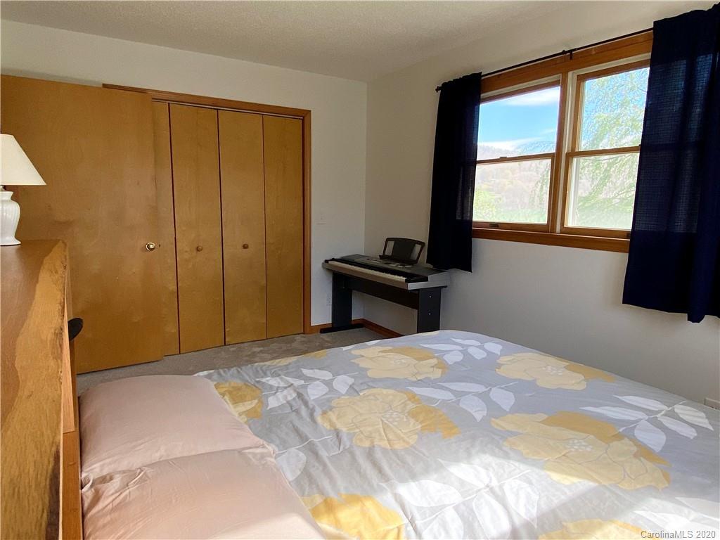 27 Morgan Branch Road Leicester, NC 28748 - Photo 24 of 39 a bedroom with a bed and a window