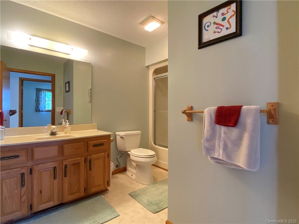 27 Morgan Branch Road Leicester, NC 28748 - Photo 27 of 39 a bathroom with a toilet a sink and mirror