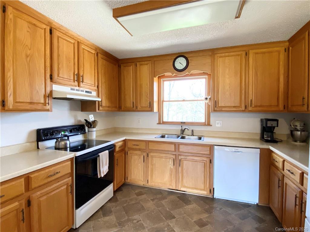 27 Morgan Branch Road Leicester, NC 28748 - Photo 5 of 39 a kitchen with stainless steel appliances granite countertop a sink stove and cabinets