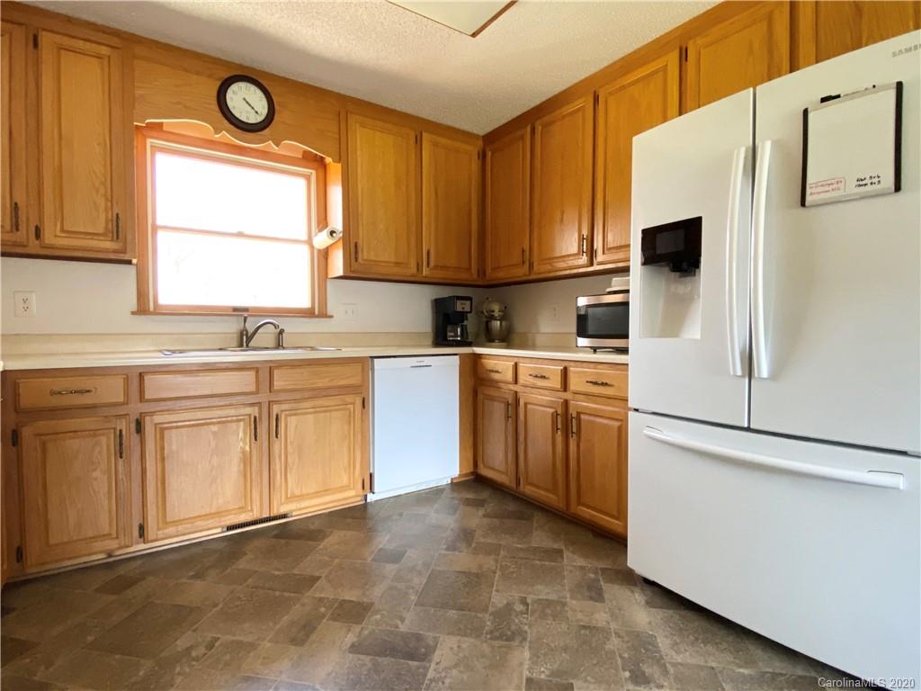 27 Morgan Branch Road Leicester, NC 28748 - Photo 6 of 39 a kitchen with white cabinets and white appliances