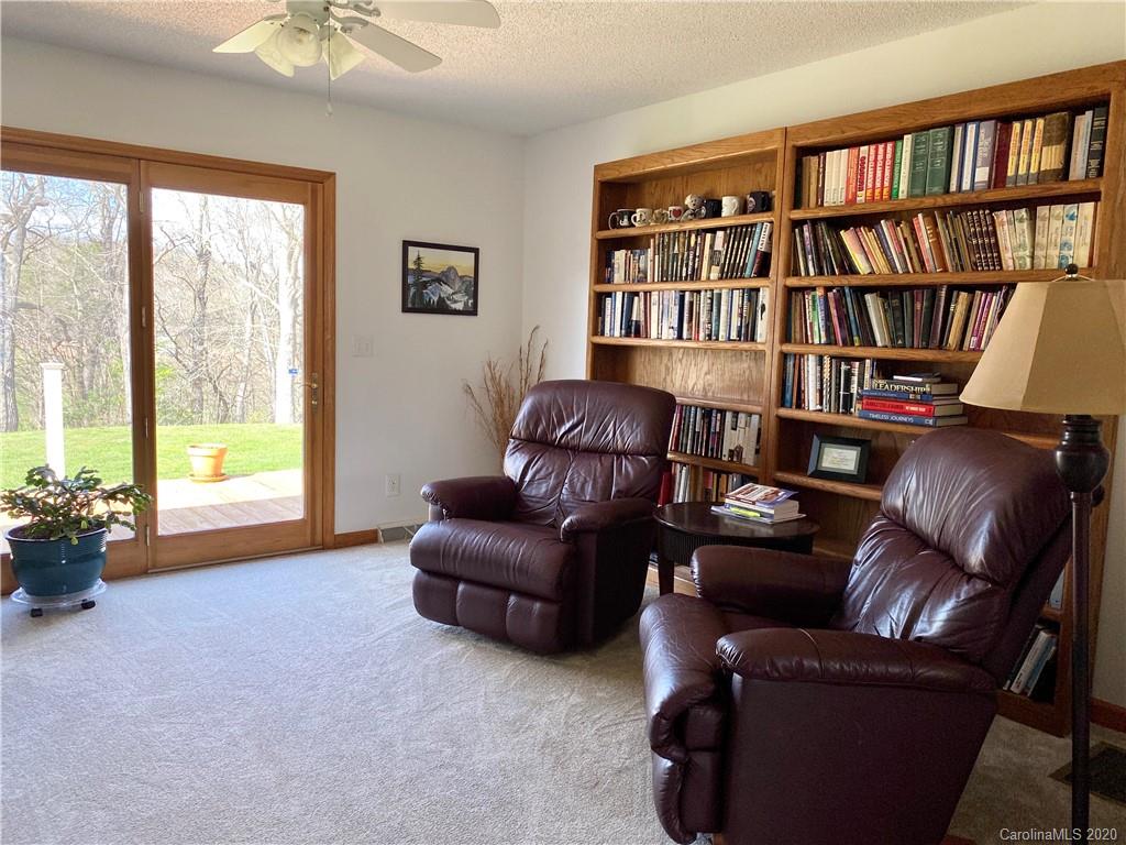 27 Morgan Branch Road Leicester, NC 28748 - Photo 10 of 39 a living room with furniture and a book shelf